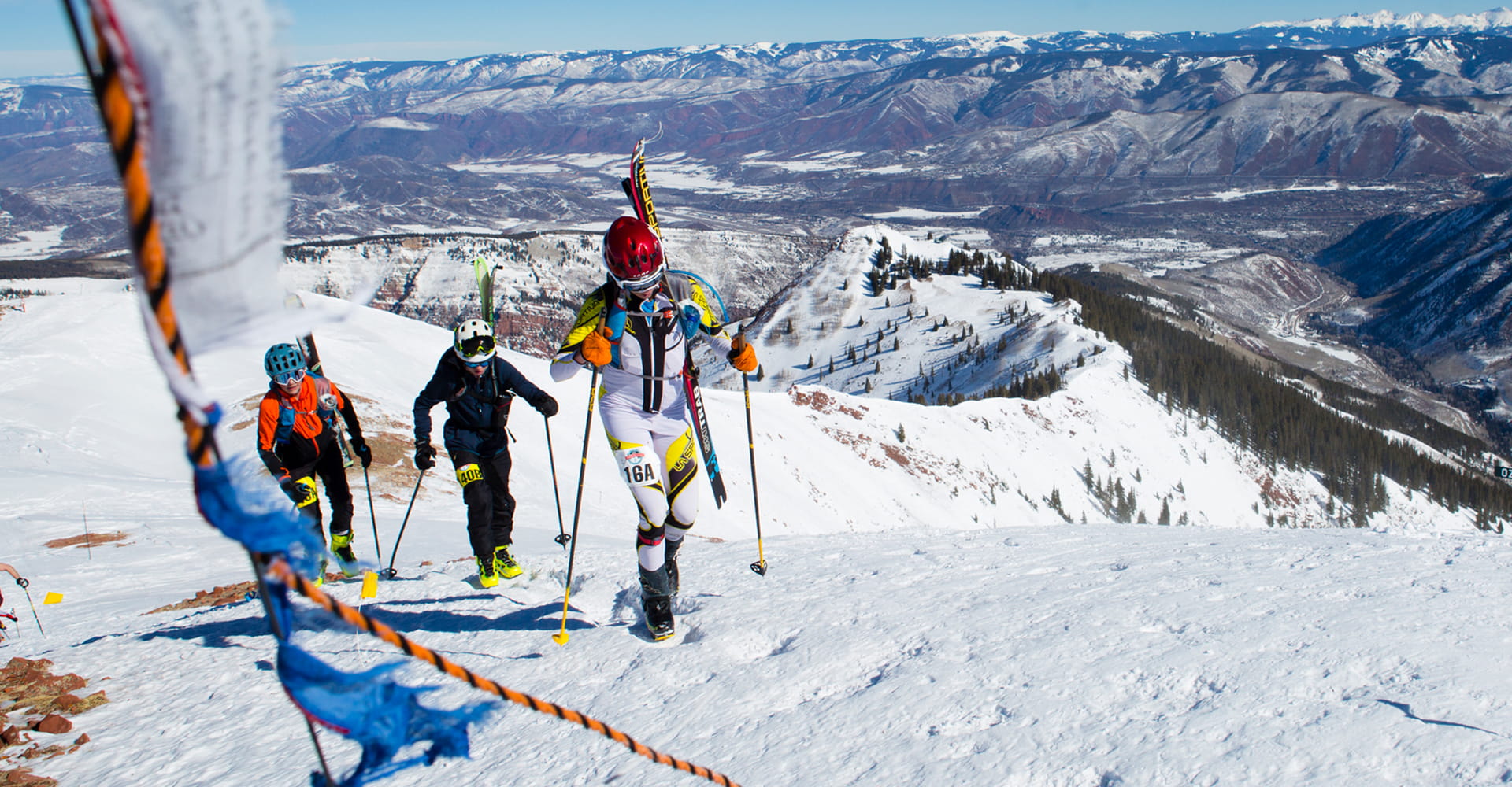 Skiers climb Highland Bowl during the Audi Power of Four Ski Mountaineering Race