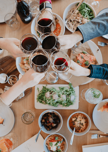 group cheers above the table at Sam's Snowmass