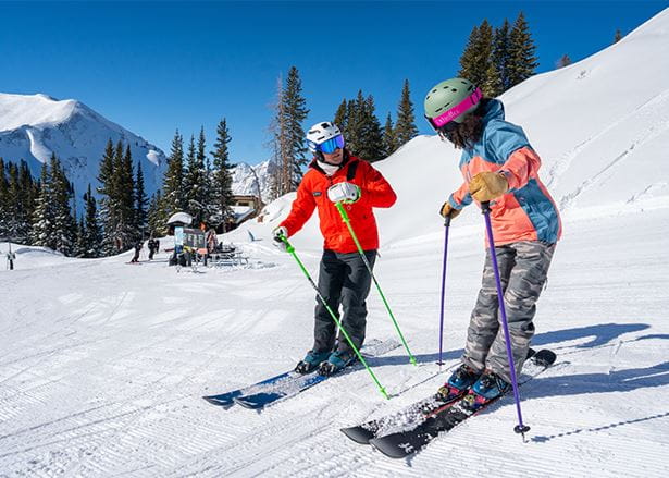 Aspen Snowmass pro teaches a client during a private lesson at Aspen Highlands