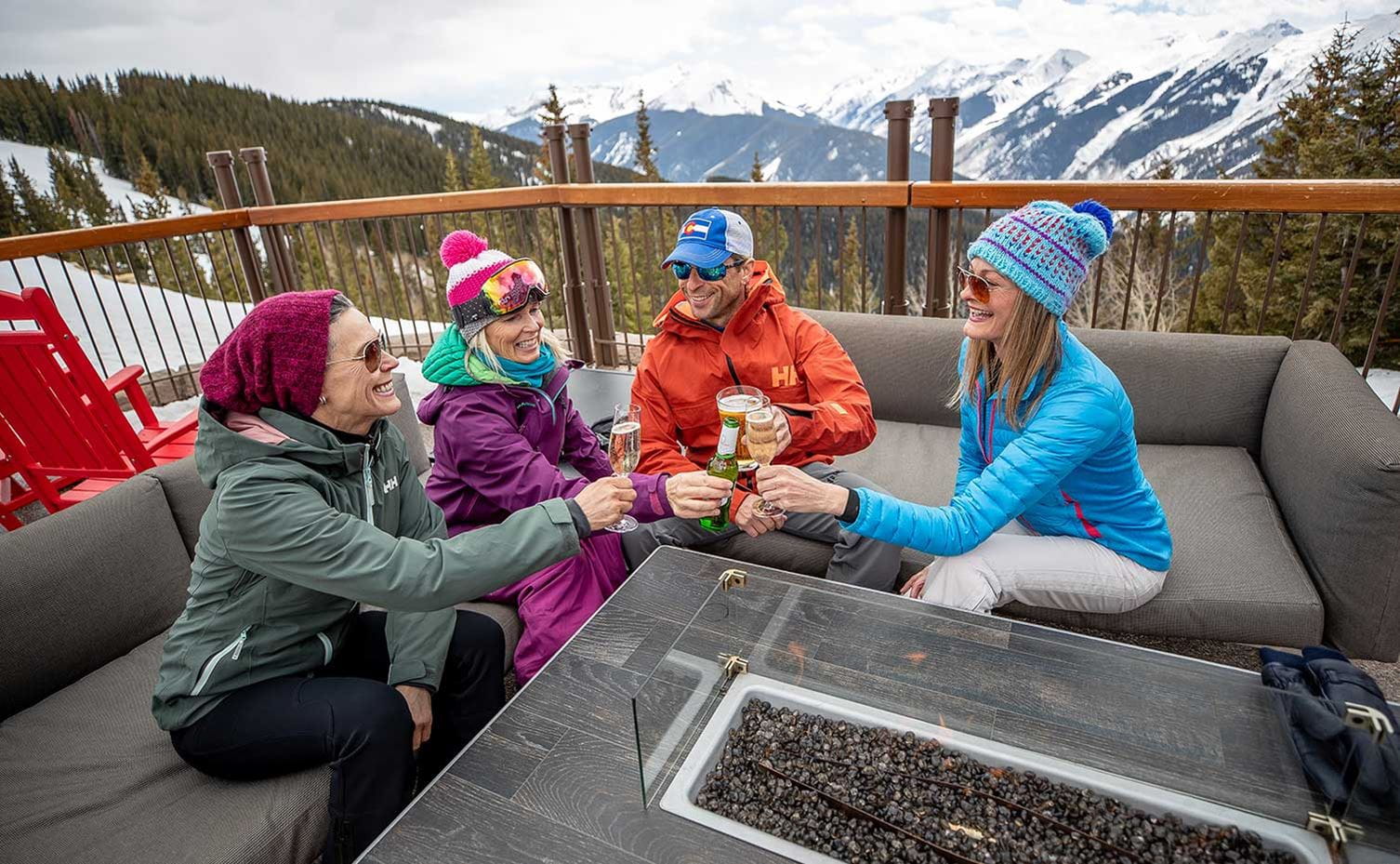Four friends toasting at the Sundeck above Aspen