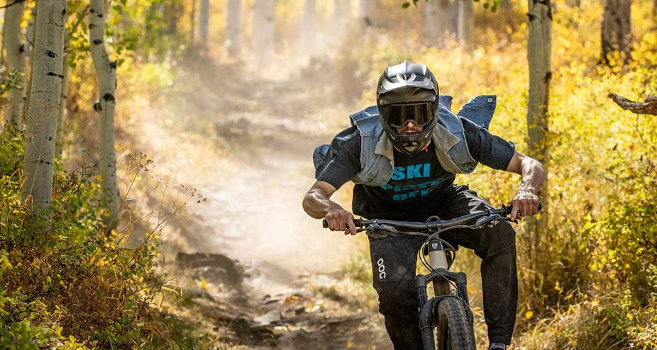 A mountain biker at Snowmass Bike Park in the fall