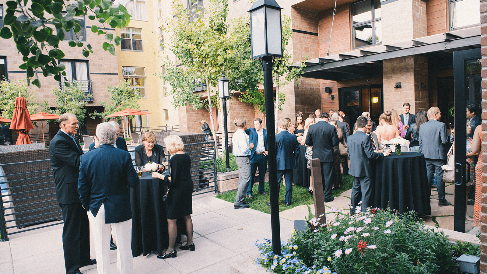 Guests gather after a the wedding in the Limelight Aspen yard, on a summer day