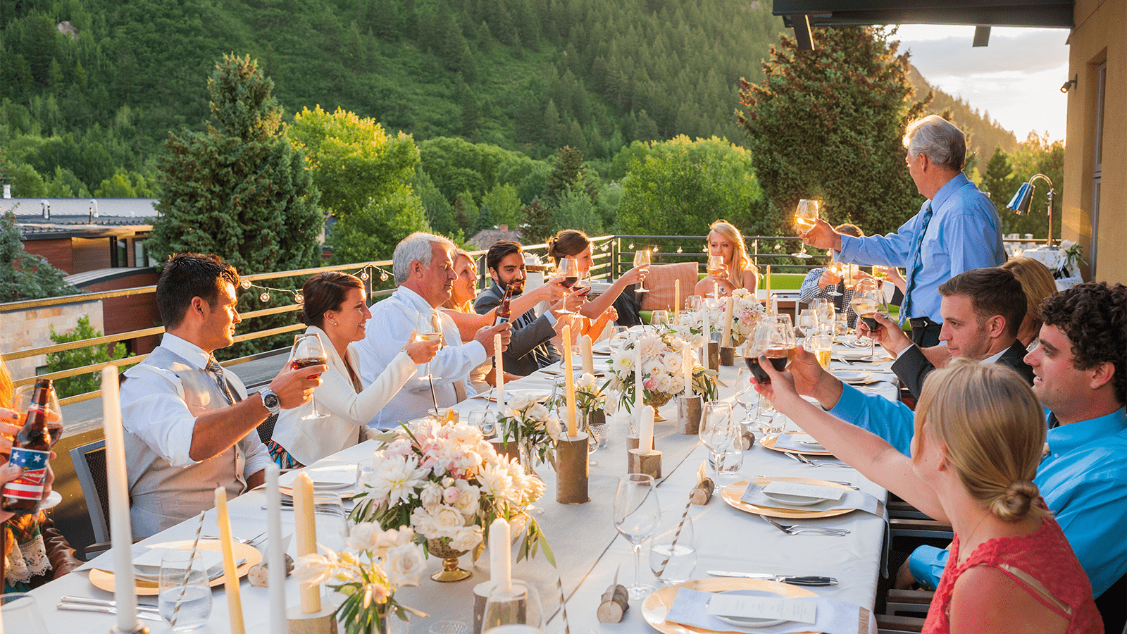 Guests hold up a toast at Limelight Aspen during a wedding rehearsal 