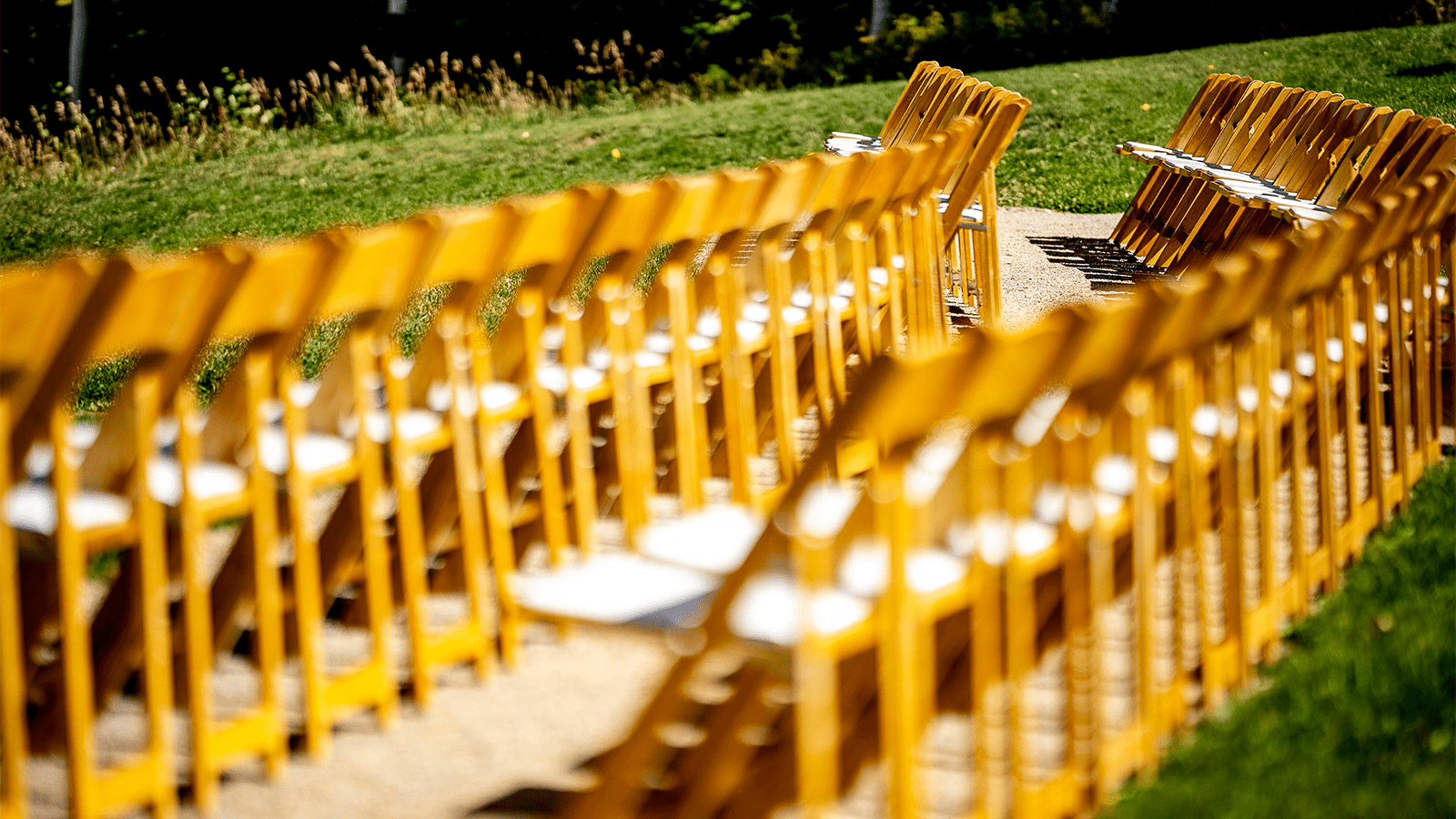 wooden wedding seats lines up in preparation for the big day