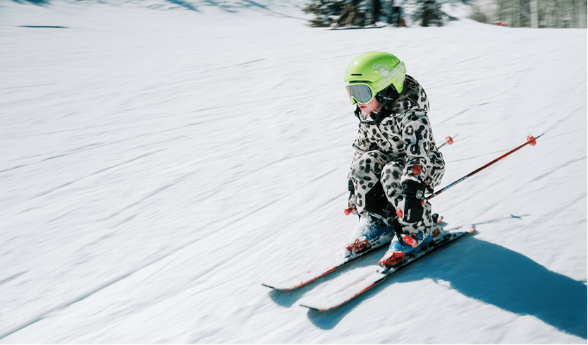small child skies down slope at buttermilk